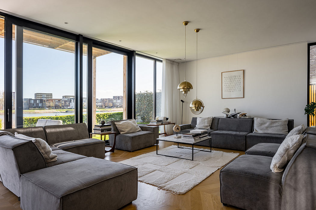 Elegant modern living room with expansive floor-to-ceiling windows, neutral color palette, and stylish furnishings.