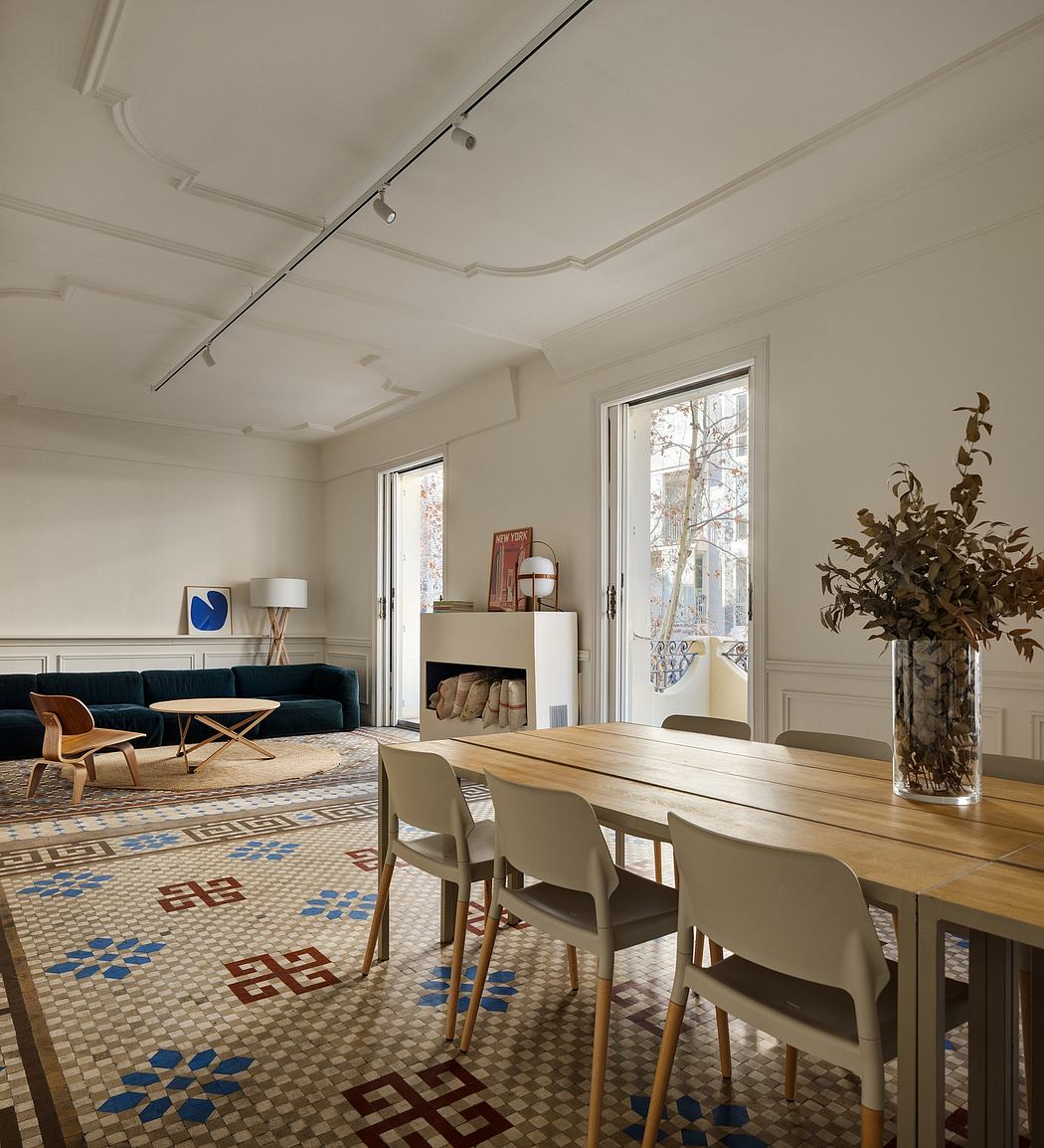 Spacious living room with intricate tiled flooring, wooden dining table, and modern furniture.