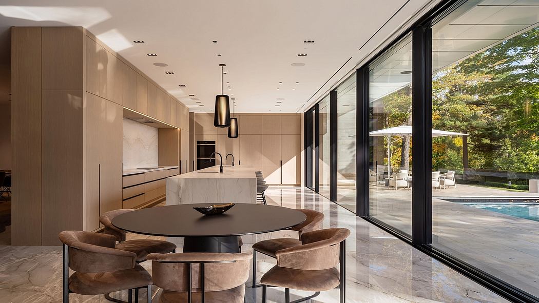 Modern kitchen with sleek cabinetry, large windows overlooking an outdoor pool area.