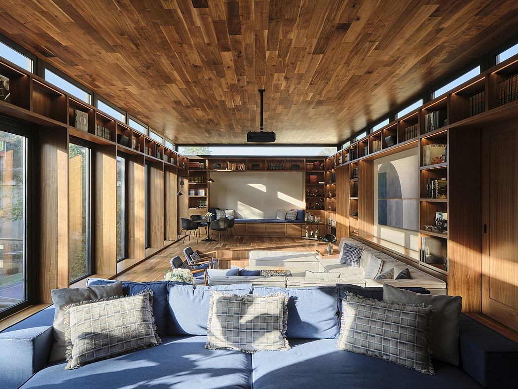 Cozy and rustic interior with wooden walls, bookshelves, and a comfortable living area.