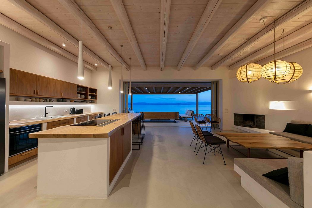 A modern kitchen and living space with a stunning lakeside view through large glass doors.