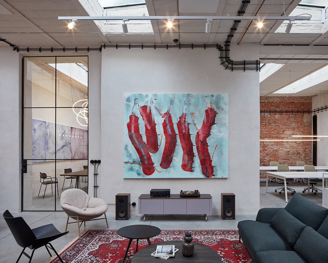 Modern, industrial-style office space with exposed brick walls, custom artwork, and an eclectic mix of furniture and decor.