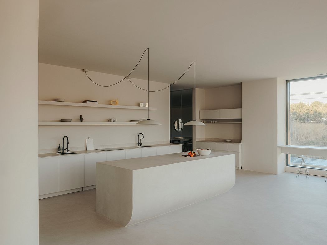 Minimalist kitchen with sleek countertops, floating shelves, and a large window providing natural light.