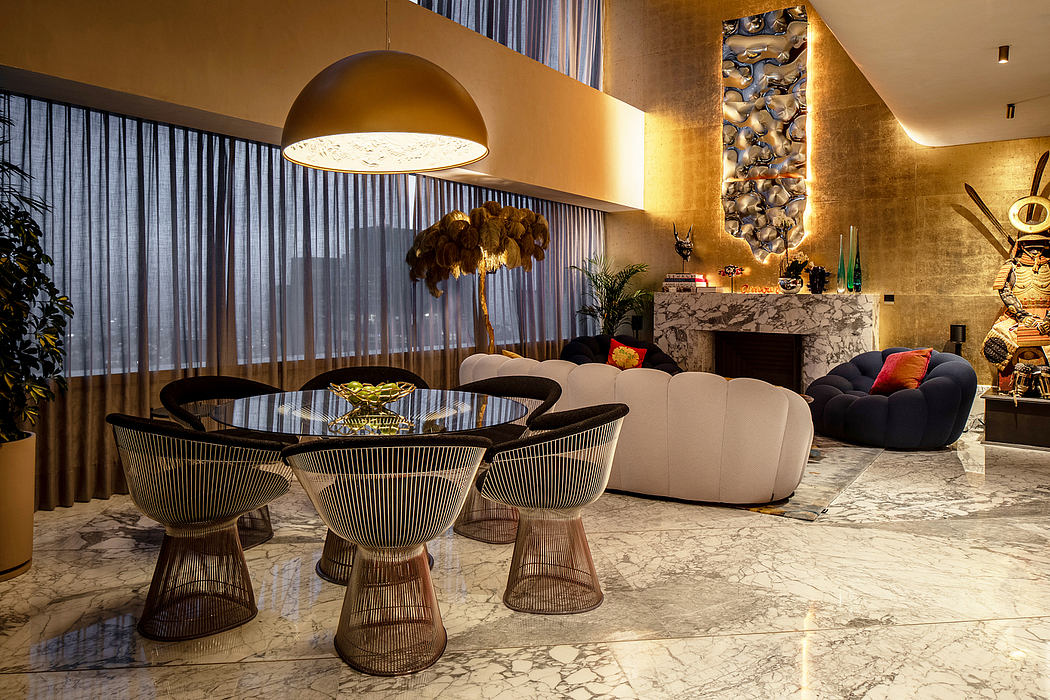 Luxurious living room with marble flooring, metallic furnishings, and a statement lighting fixture.