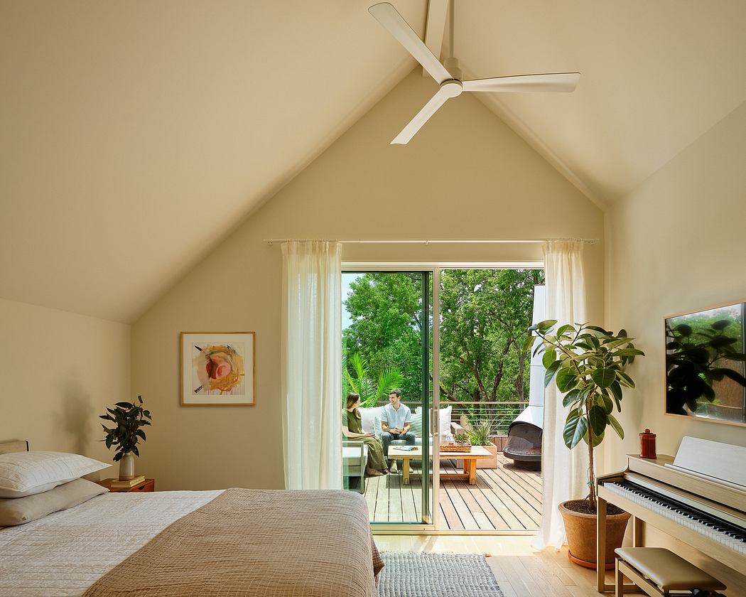 Spacious bedroom with vaulted ceiling, ceiling fan, and large sliding glass doors leading to a deck.