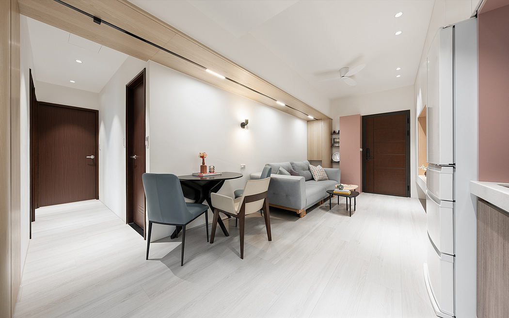 Sleek, minimalist apartment with light flooring, modern furniture, and recessed lighting.