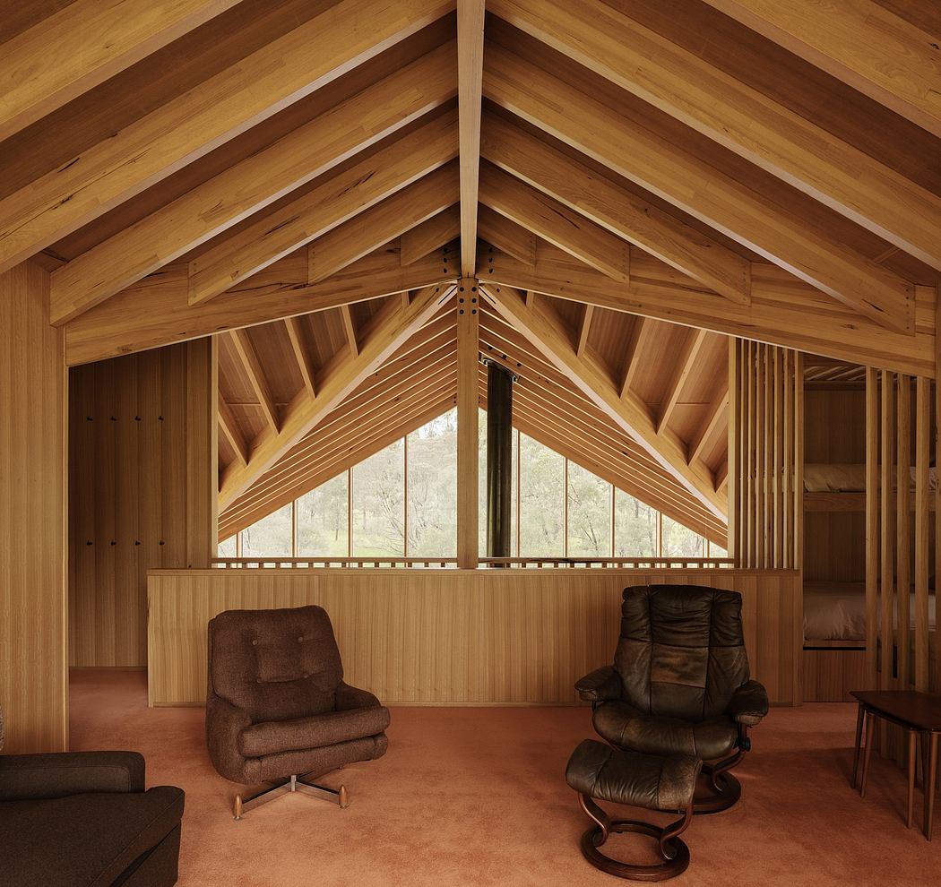 A cozy interior with a warm, wooden vaulted ceiling and comfortable leather chairs.