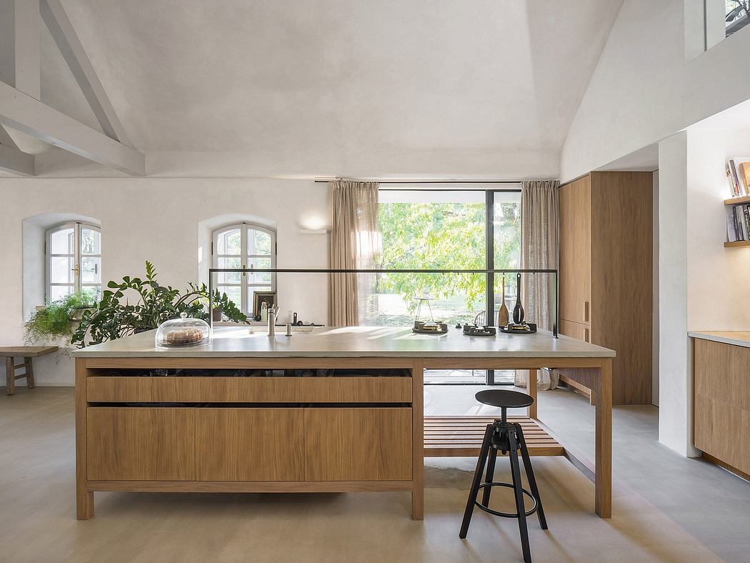 A bright, modern kitchen with arched windows, wooden cabinetry, and a central island.