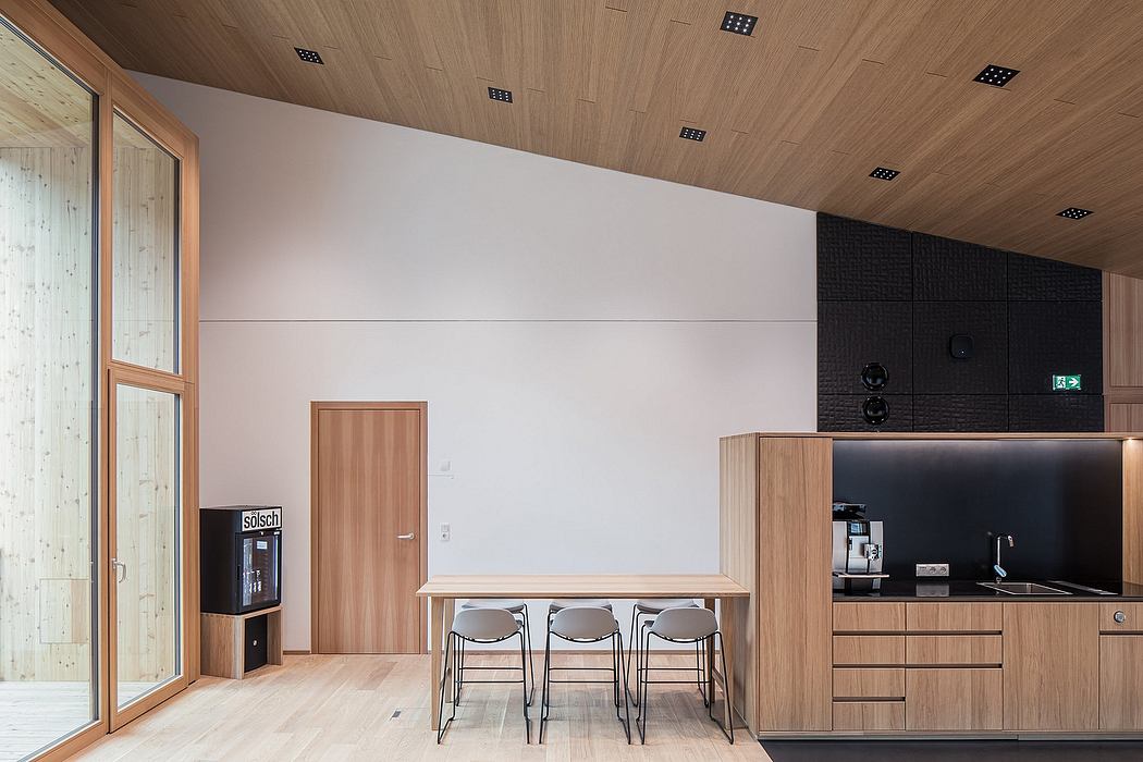 Modern, minimalist interior with warm wood tones, sleek cabinetry, and a minimalist dining area.