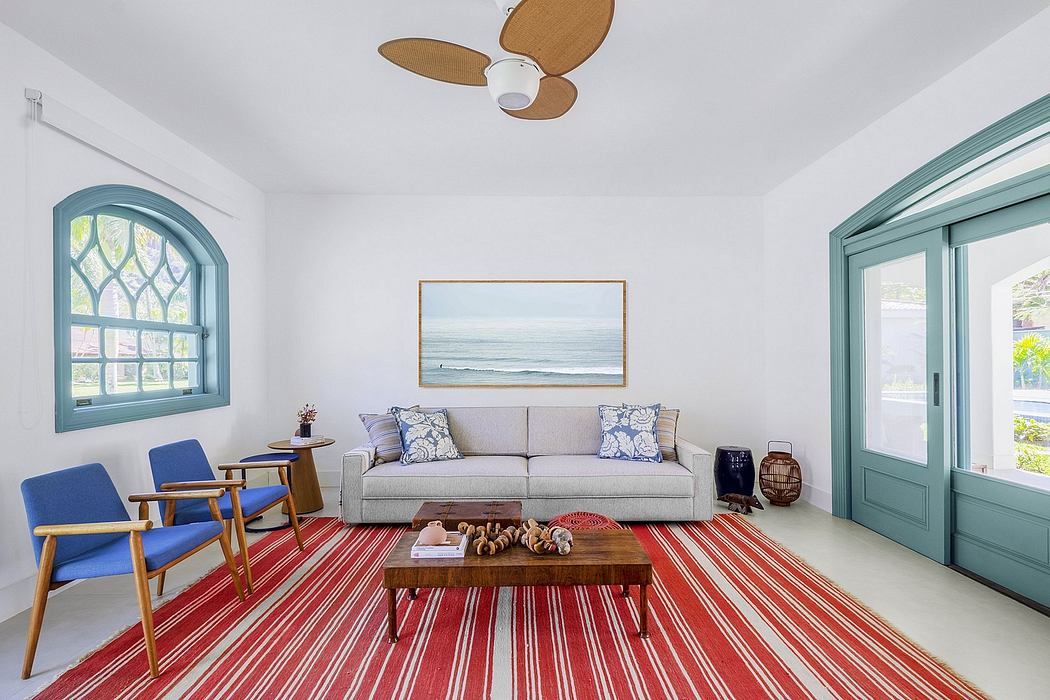 Bright, airy living room with arched windows, coastal-inspired decor, and patterned rug.