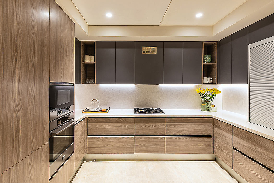 Sleek, minimalist kitchen design with grey cabinetry, wood accents, and built-in appliances.