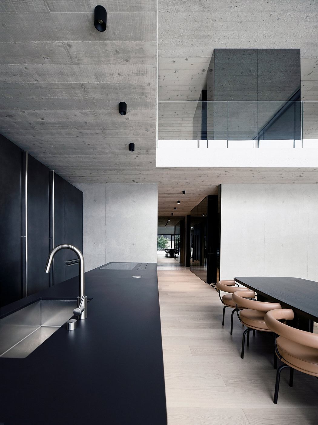 Minimalist concrete architecture with dark tones, geometric forms, and sleek furnishings.