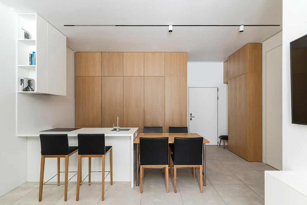 Minimalist interior design with sleek wood paneling, modern kitchen, and dining area.