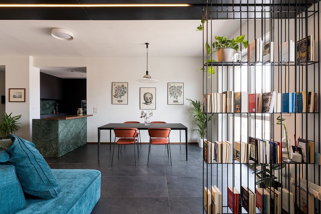 Sleek modern interior with open floor plan, black furniture, and industrial-style shelving.