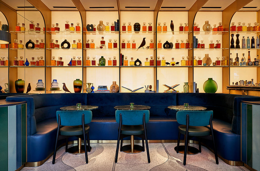 A vibrant, retro-inspired bar with shelves displaying an array of colorful bottles.
