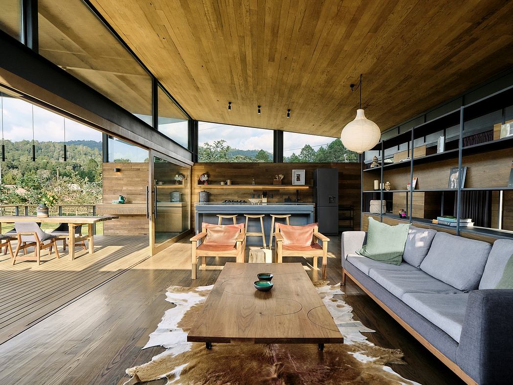 Spacious open-plan living area with large windows, wooden ceiling, and mid-century furniture.