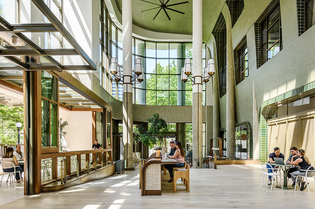 Spacious lobby with floor-to-ceiling windows, wooden furnishings, and modern lighting fixtures.
