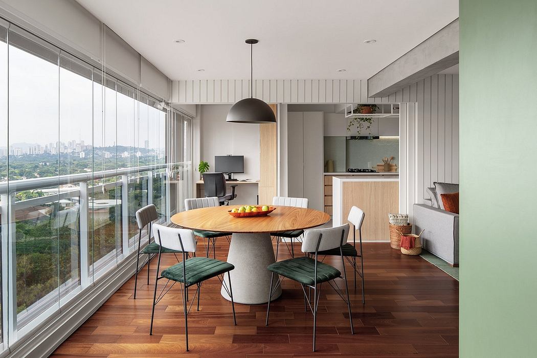 Modern dining area with round table, chairs, and large window overlooking cityscape.