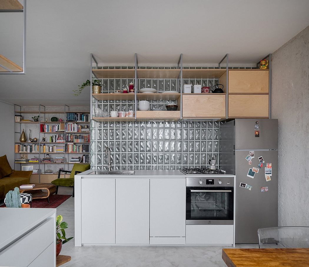 Modern minimalist kitchen with ample open storage, sleek white cabinets, and concrete walls.