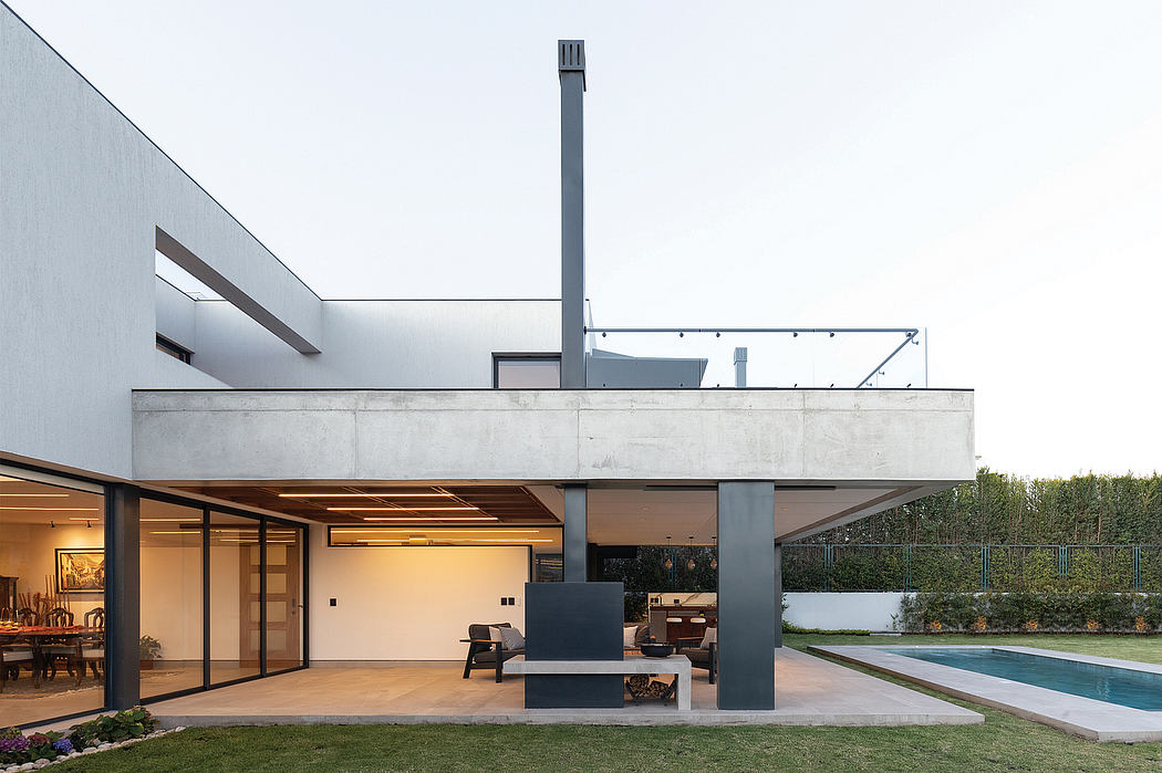 Contemporary concrete and glass structure with a modern outdoor living space and swimming pool.