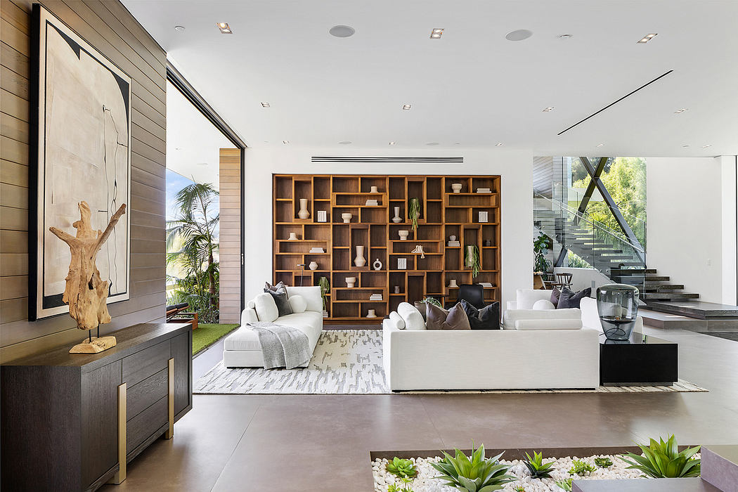 Spacious modern living room with expansive shelving, natural elements, and open layout.