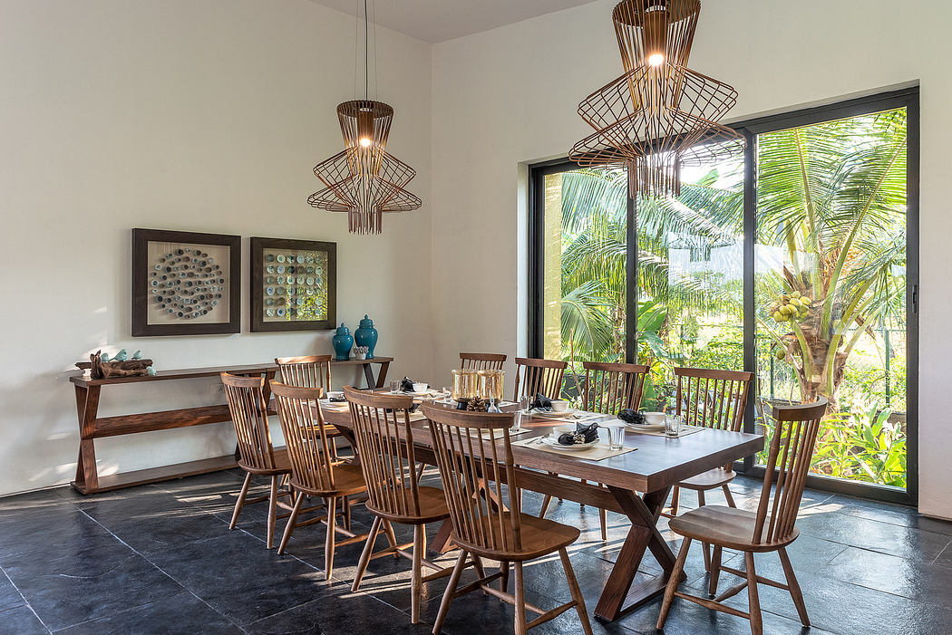 Rustic dining room with wooden furniture and large windows overlooking lush greenery.