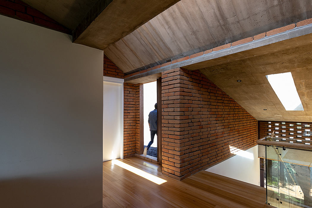 An interior with exposed brick walls, wooden beams, and a balcony framed by a window. Minimalist design.