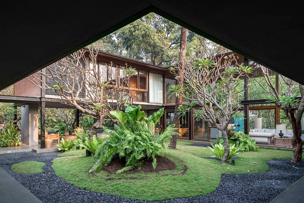 A modern, wooded house with large windows, lush greenery, and a tranquil, natural setting.