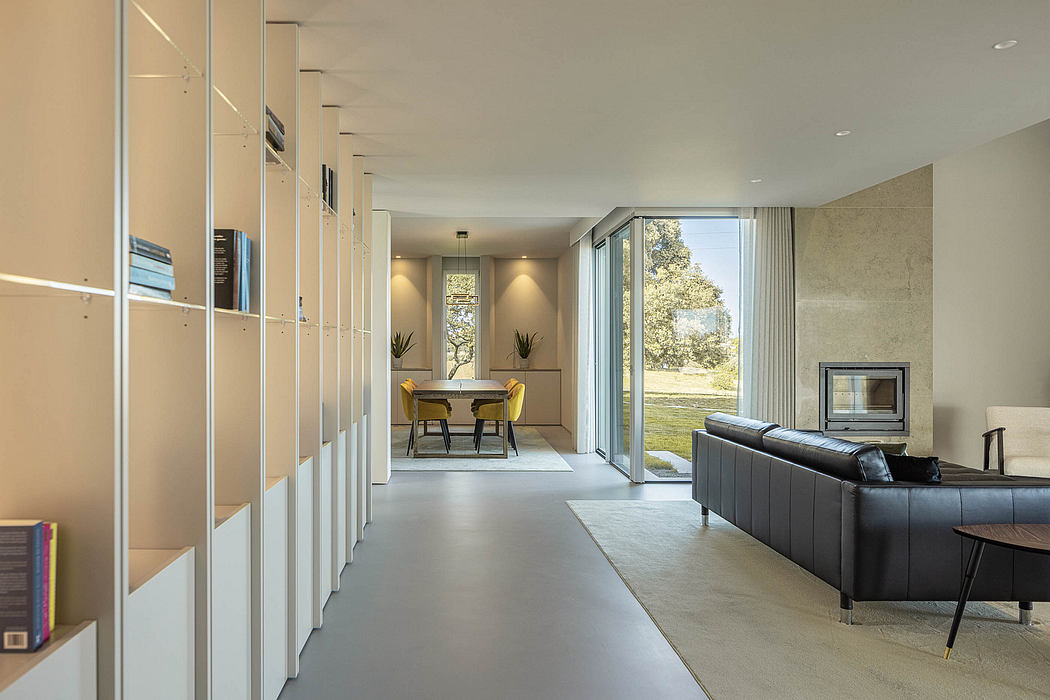 Spacious modern interior with minimalist furnishings, large windows, and built-in storage.