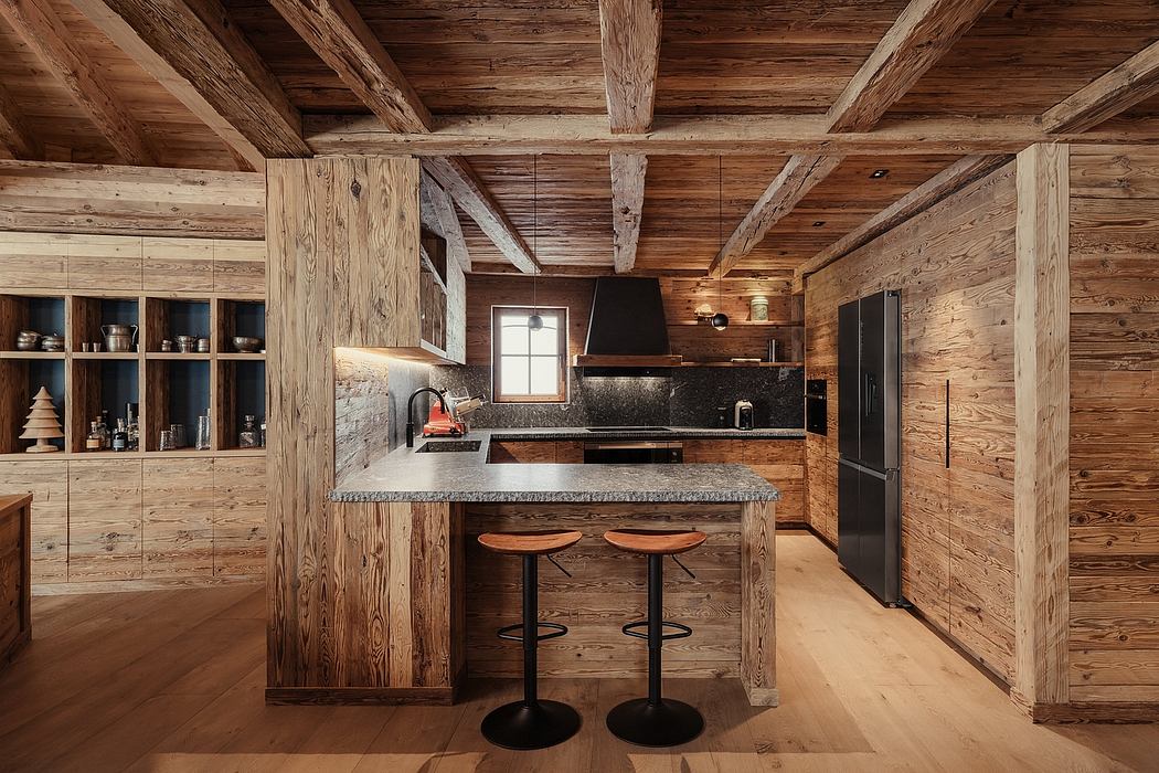 A rustic kitchen with wooden beams, stone countertops, and a cozy, cabin-like atmosphere.