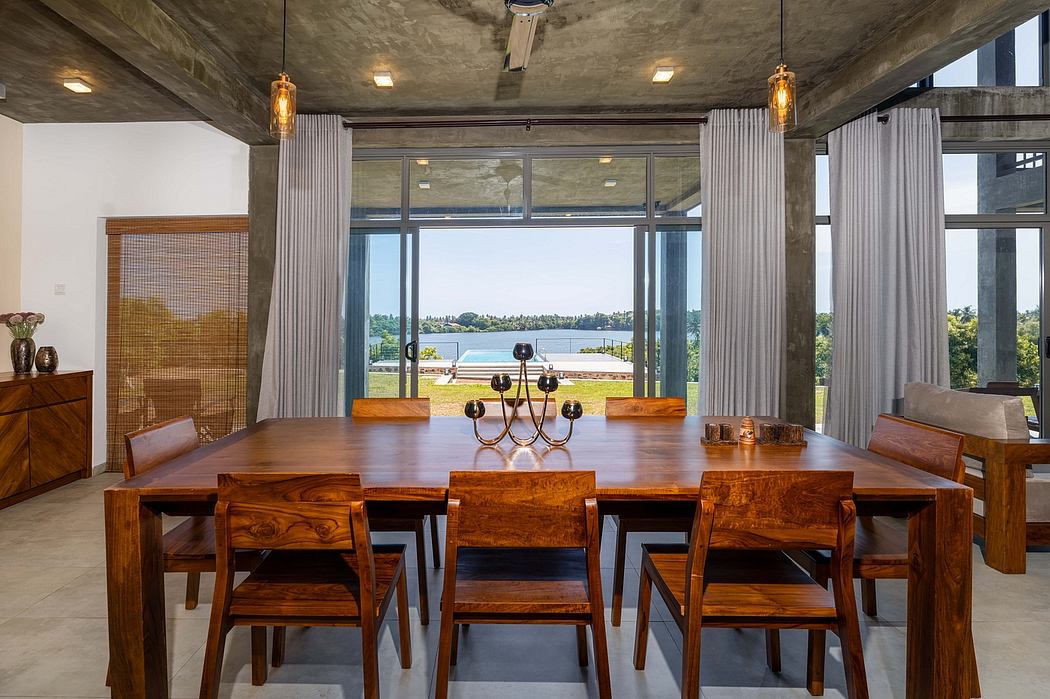 Spacious dining room with large windows, concrete ceiling, and wooden furniture.