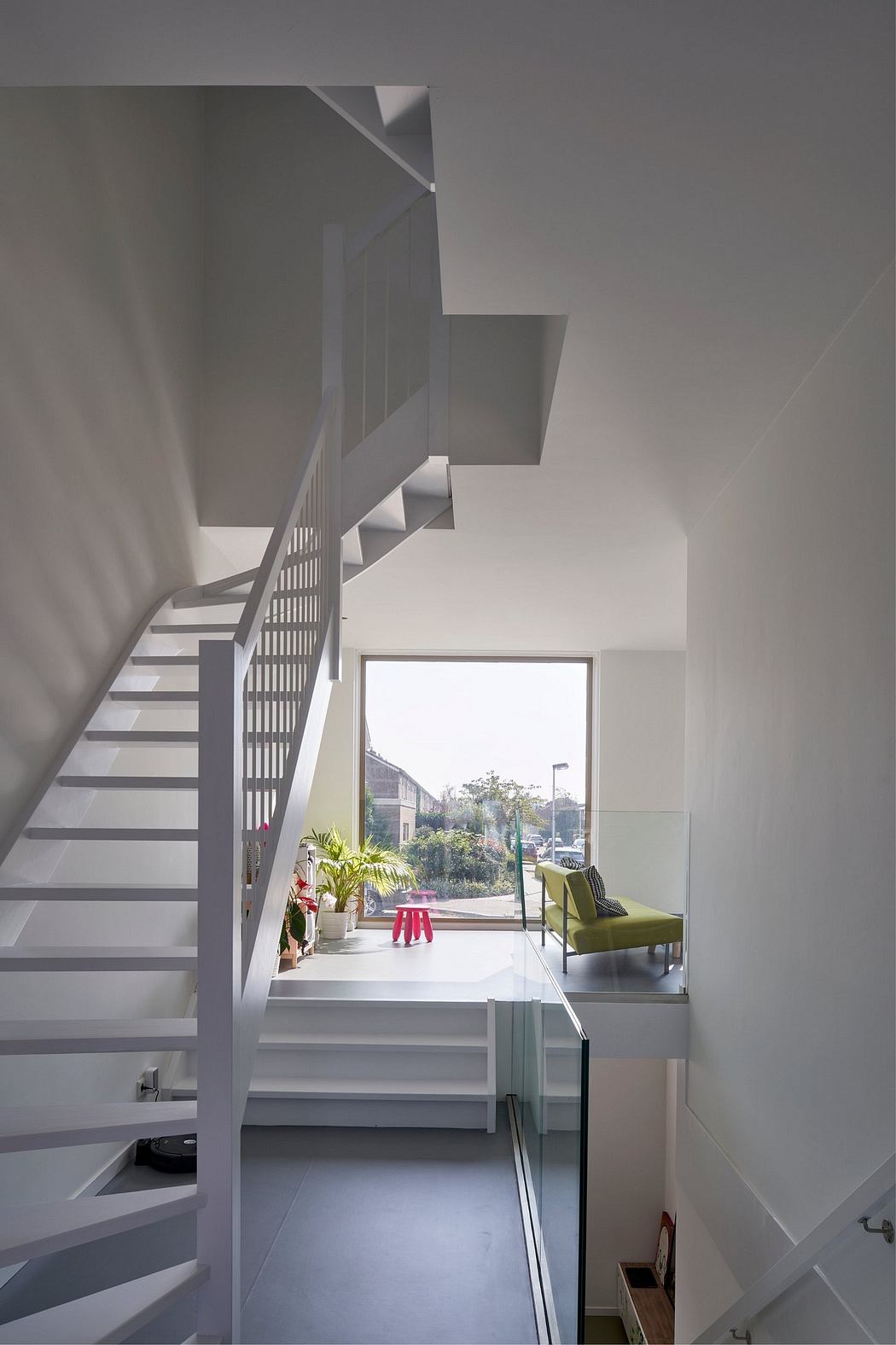 Modern staircase with geometric design and bright, airy interior.