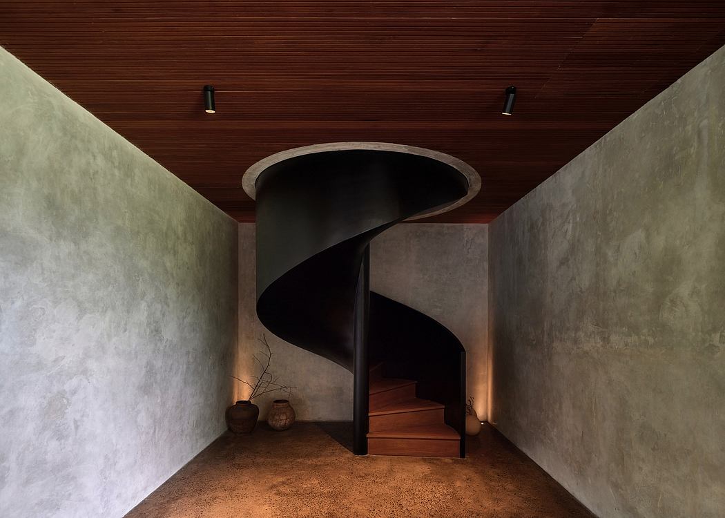 Spiral staircase in a rustic, wood-paneled interior with subtle lighting.