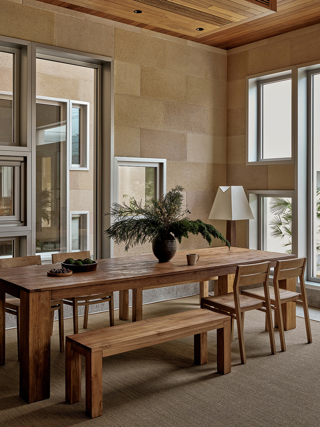 Inviting rustic dining space with wooden furniture, stone walls, and natural accents.