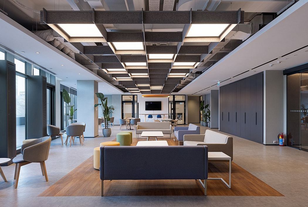 Expansive open-concept office space with modern lighting fixtures and furniture.