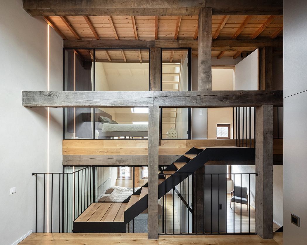 A modern rustic interior with exposed wooden beams, metal railings, and an open loft design.