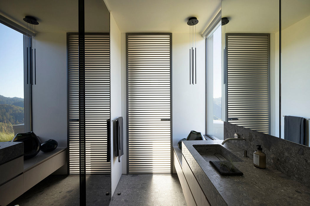 A modern bathroom with sleek wooden blinds, minimalist fixtures, and a stone vanity.