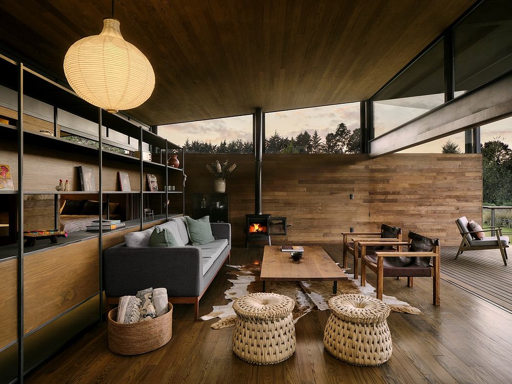 Cozy cabin-style living room with wooden walls, fireplace, and modern furnishings.