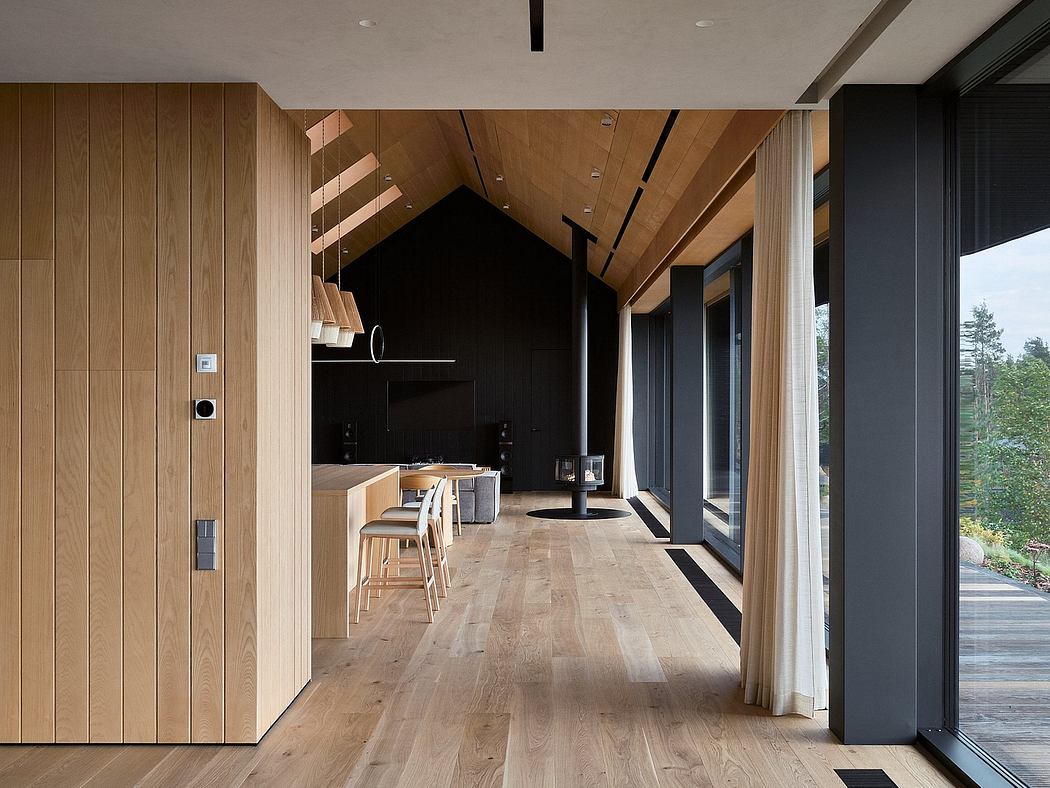 Spacious modern interior with wood paneling, large windows, and minimalist furnishings.