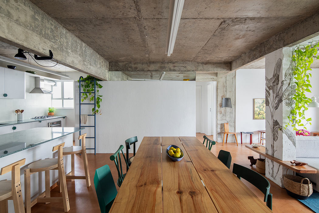 An open-concept kitchen and dining area with a rustic, industrial vibe featuring concrete walls and wooden furniture.