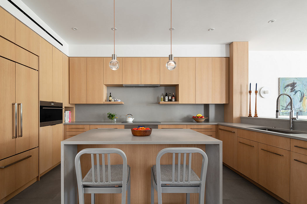 A modern kitchen with clean lines, natural wood cabinets, and a central island with barstools.