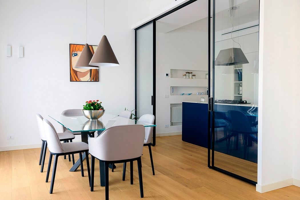 Sleek, modern dining room with glass table, pendant lamps, and vibrant artwork.