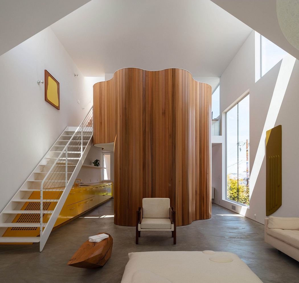 Striking architectural features: curved wood panels, stairs, and ample natural light.