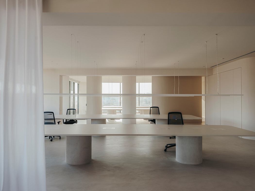 Elegant, minimalist office space with clean lines, large windows, and modern furniture.