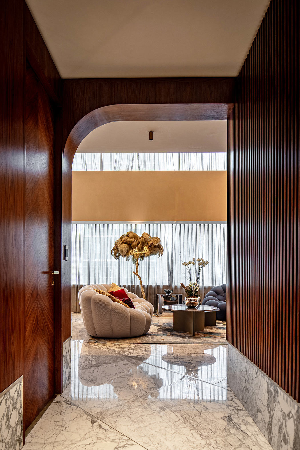 A luxurious and stylish interior space with intricate wooden paneling, plush furnishings, and a striking marble floor.