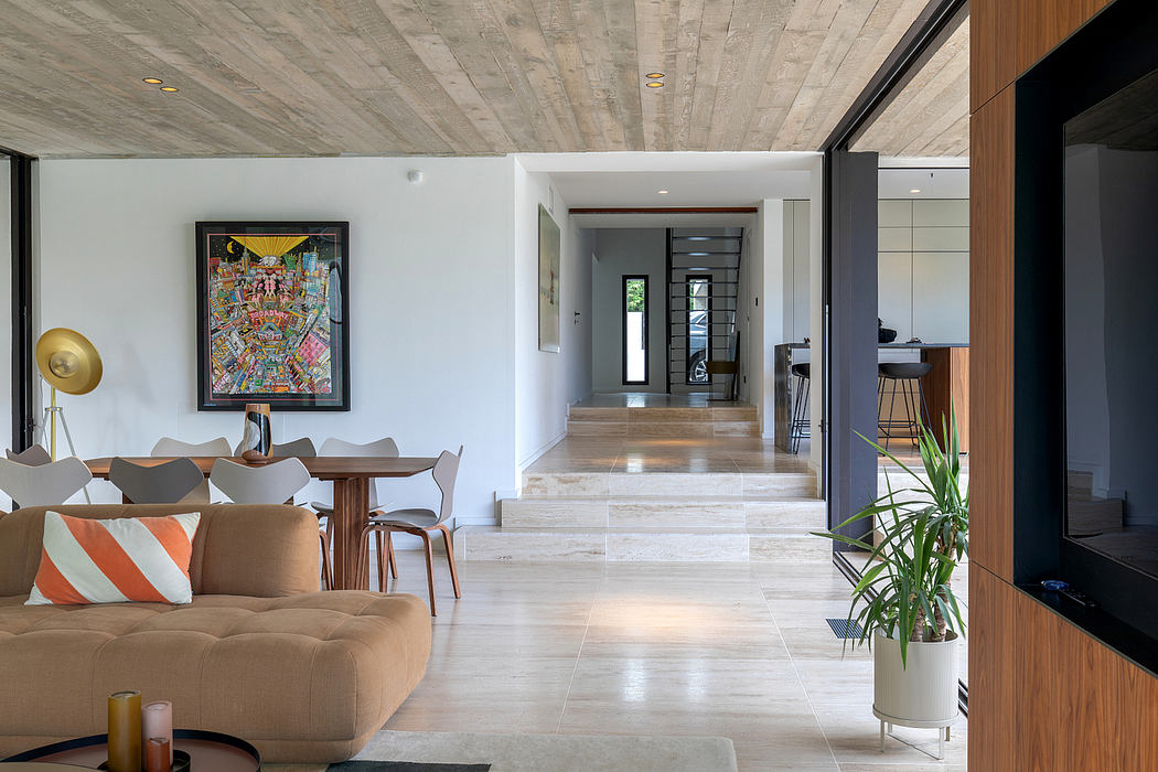 Modern open-concept living space with concrete ceiling, white walls, and tiled flooring.