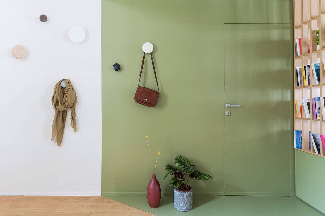 Well-designed modern entry with earthy textures, minimalist shelving, and a touch of greenery.