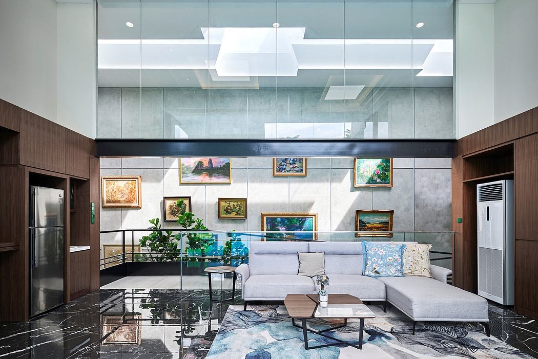 Sleek, modern lounge with a glass wall, recessed lighting, and artistic wall decor.