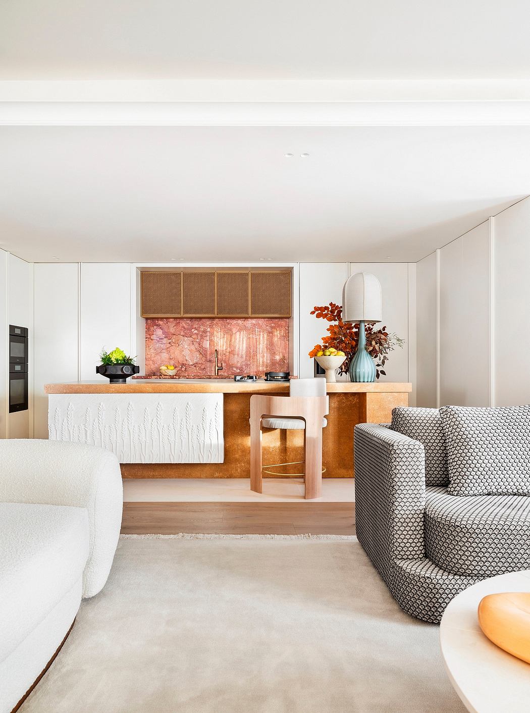 A minimalist kitchen design with warm wood tones and a stylish patterned couch.
