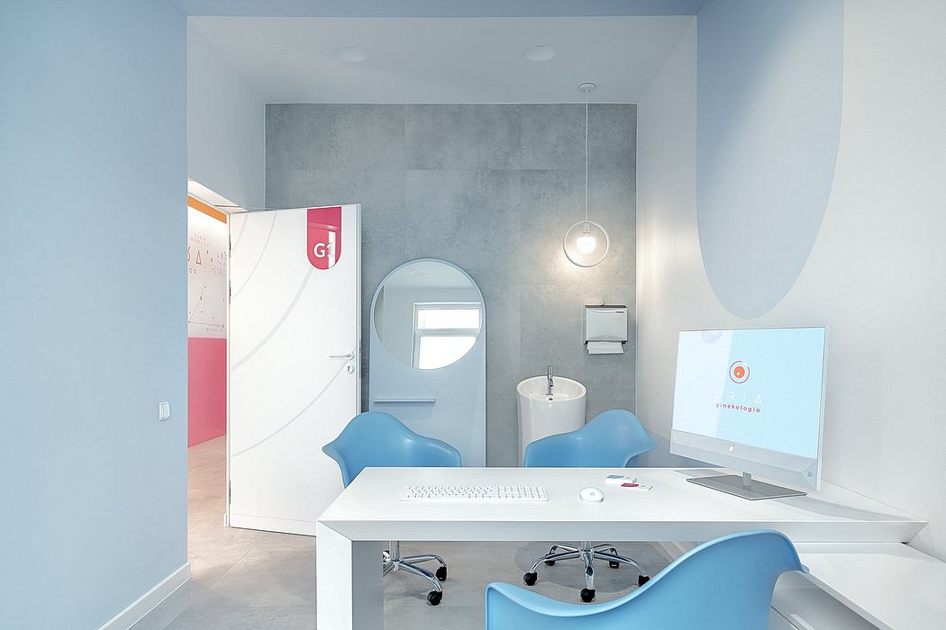 A modern, minimalist interior design featuring a white desk, blue chairs, and concrete walls.